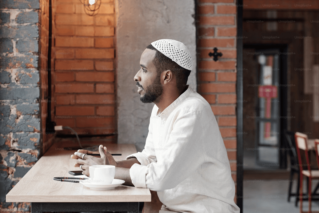 Muslim man sitting in a coffee shop