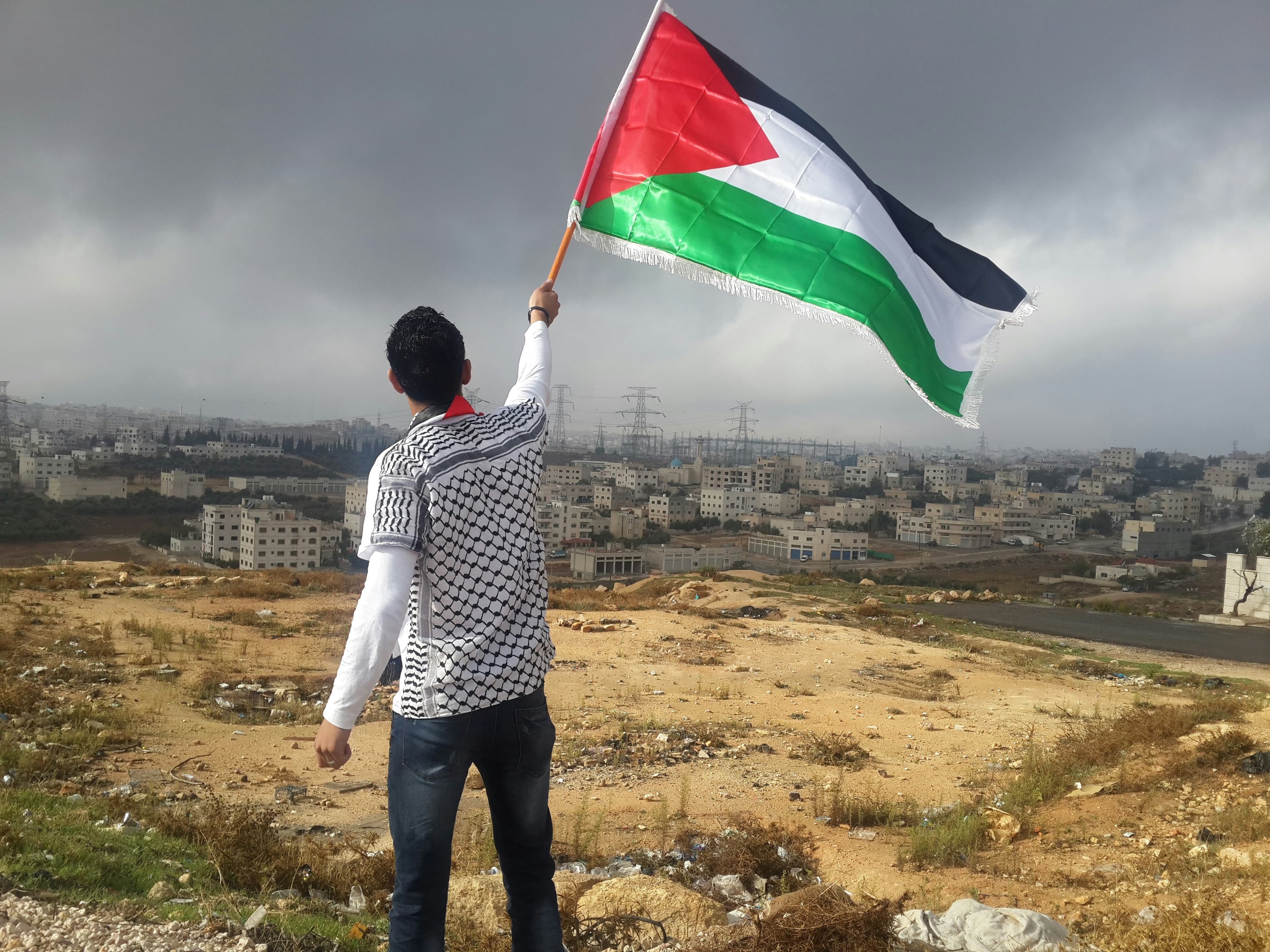 Man raising Palestinian flag
